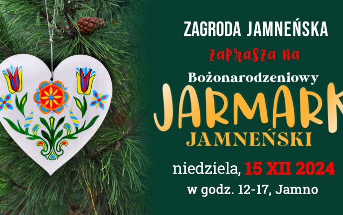 Grafika przedstawia kolorową ozdobę świąteczną w kształcie serca na tle gałęzi świerku